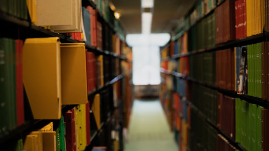 Aisle of book shelves in a library